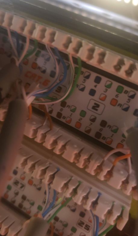 A telecom punch-down block with color-coded twisted pairs landed in order
